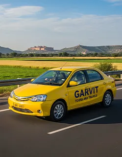 Garvit Tours and Travels taxi driving on the road in Jaipur with scenic Rajasthan landscape