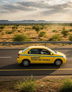 Garvit Tours and Travels taxi driving on the road from Jhunjhunu to Jaipur with scenic Rajasthan view